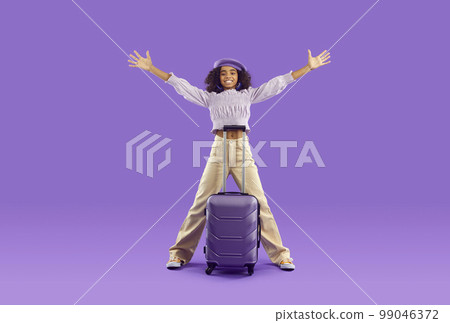 Happy cheerful tourist girl with purple suitcase excited about going on summer holiday 99046372