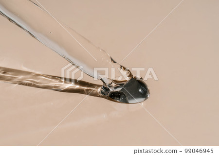 A drop of cosmetic oil falls from the pipette A drop of cosmetic oil falls from the pipette 99046945