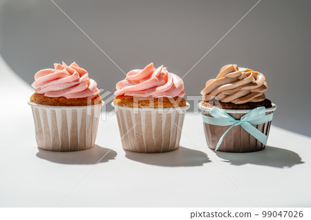 Cupcakes on a white sunny background with a shadow. Cupcakes on a white sunny background with a shadow. 99047026