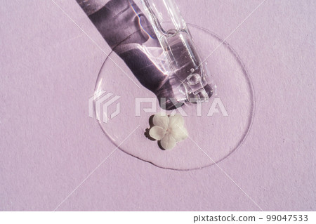 A cosmetic product flows out of a pipette with bubbles. 99047533