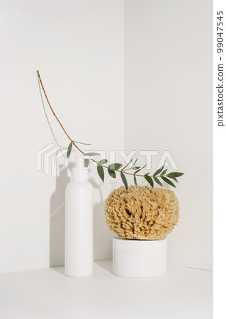 Serum and natural sponges on a light background. Serum and natural sponges on a light background. 99047545