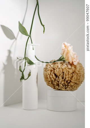 Serum and natural sponges on a light background. Serum and natural sponges on a light background. 99047607