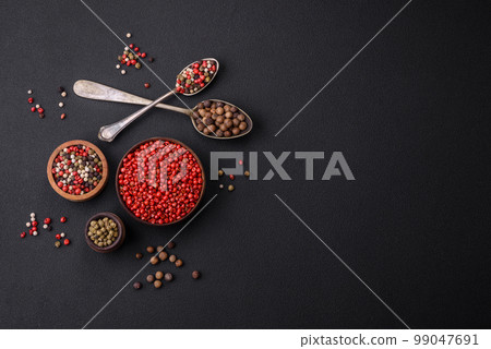 Composition, concept, consisting of several types of different colors of allspice in bowls and spoons Composition, concept, consisting of several types of different colors of allspice in bowls and spoons 99047691