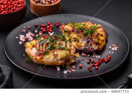 Meat baked in the oven with pineapple, tomatoes, cheese, spices and herbs Meat baked in the oven with pineapple, tomatoes, cheese, spices and herbs 99047753