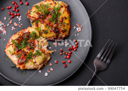 Meat baked in the oven with pineapple, tomatoes, cheese, spices and herbs Meat baked in the oven with pineapple, tomatoes, cheese, spices and herbs 99047754