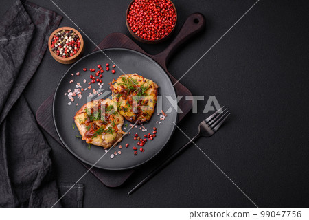 Meat baked in the oven with pineapple, tomatoes, cheese, spices and herbs Meat baked in the oven with pineapple, tomatoes, cheese, spices and herbs 99047756