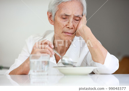 Sick asian senior woman suffering from anorexia,bored with meal,eating less food,discomfort in swallowing,disease of Dysphagia,Old elderly patient with Anorexia-Cachexia syndrome,lack of appetite 99048377