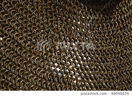 Protective old military chain mail, close-up. Mail made of round metal rods for the protection of a warrior. 99048839