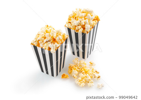 Two black white striped carton buckets with tasty cheese popcorn, isolated on white background Two black white striped carton buckets with tasty cheese popcorn, isolated on white background 99049642