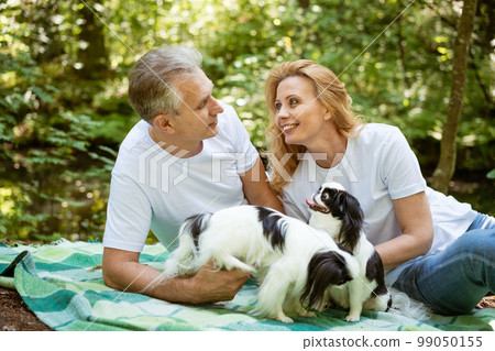 Senior couple on a picnic in the woods 99050155