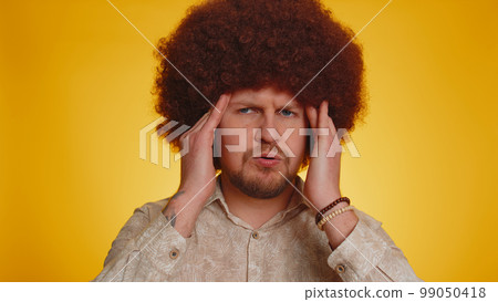 Sick man rubbing temples to cure headache problem, suffering from tension and migaine, stress, pain 99050418