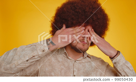 Man closing eyes with hand showing stop gesture confused shy scared to watch, dont want to look Man closing eyes with hand showing stop gesture confused shy scared to watch, dont want to look 99050430