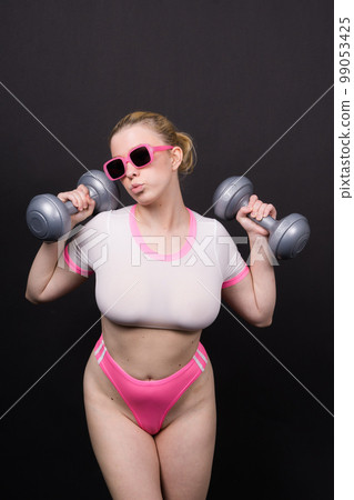 Strong sportswoman in boxing gloves prepared high kick. Isolated on white, red, yellow background 99053425