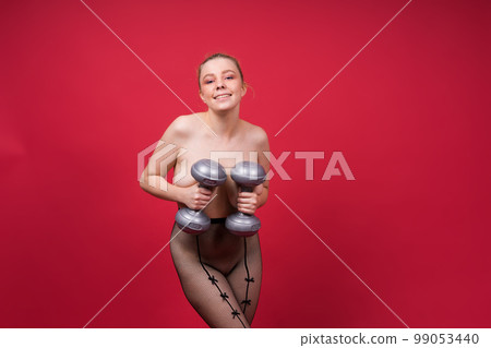 Strong sportswoman in boxing gloves prepared high kick. Isolated on white, red, yellow background 99053440