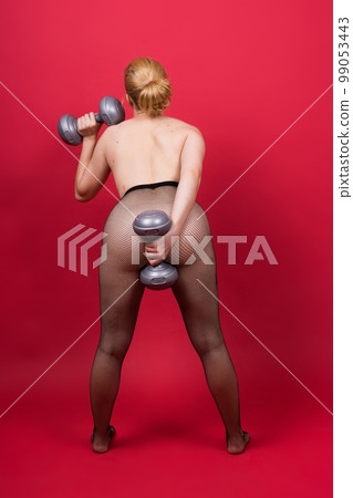 Strong sportswoman in boxing gloves prepared high kick. Isolated on white, red, yellow background 99053443