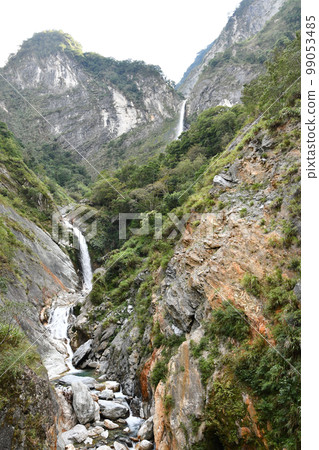 Vertical shot of a river flowing through rocks in Xiulin, Hualien, Taiwan 99053485