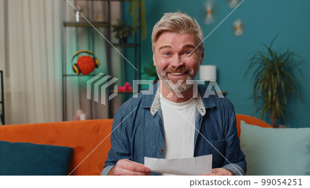 Old man open envelope letter reads it feel happy, career growth advance promotion, bank loan approve 99054251