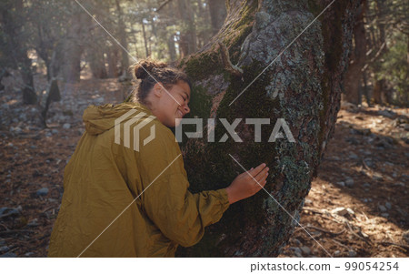 caucasian woman enjoys being in nature, 99054254