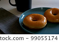 Glazed donuts and chic mugs, lunchomat table interior 99055174