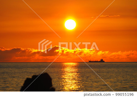 Sea and horizon with sunset sunset reflections, silhouette of tanker Sea and horizon with sunset sunset reflections, silhouette of tanker 99055196