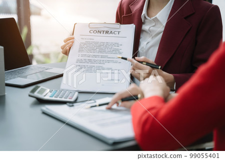 Real estate broker agent presenting and consult to customer to decision making sign insurance form agreement, home model, concerning mortgage loan offer. 99055401