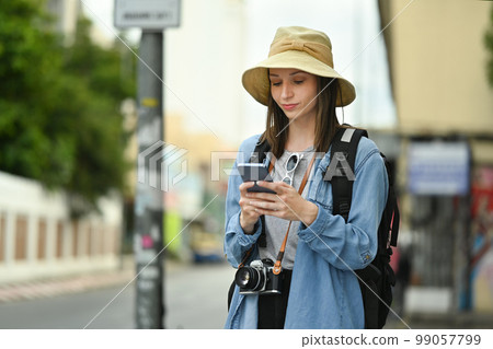 Pretty female traveler with backpack on holiday vacation trip in Thailand and using mobile phone for searching direction Pretty female traveler with backpack on holiday vacation trip in Thailand and using mobile phone for searching direction 99057799