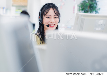A telephone operator serving customers with a smile A telephone operator serving customers with a smile 99058693