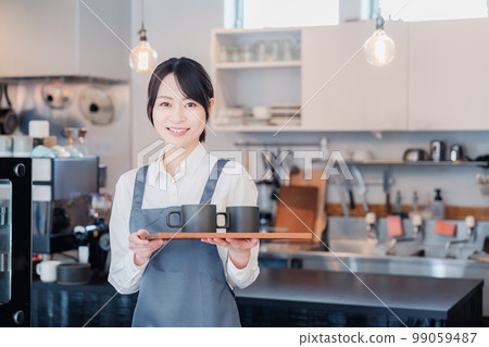A woman working as a cafe hall staff 99059487