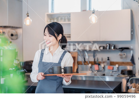 A woman working as a cafe hall staff 99059496