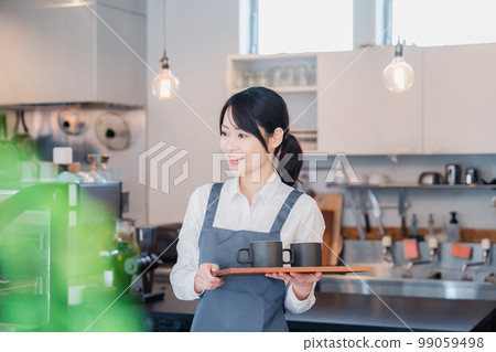 A woman working as a cafe hall staff A woman working as a cafe hall staff 99059498