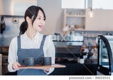 A woman working as a cafe hall staff 99059501