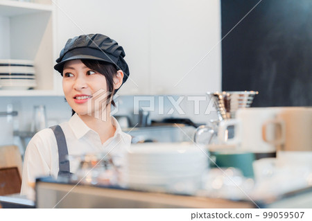 A woman working as a cafe hall staff A woman working as a cafe hall staff 99059507