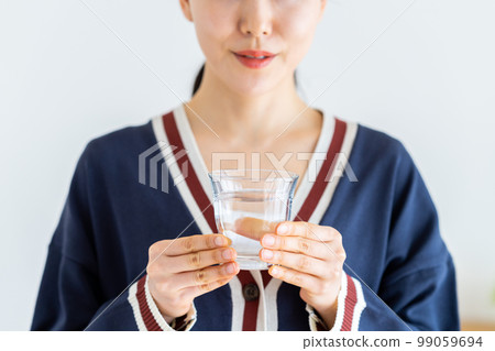 A young woman drinking mineral water 99059694