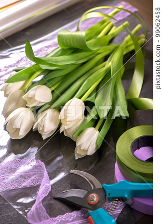 image of holiday gift packaging. sale and packaging of flowers. Bouquet of white tulips 99062458