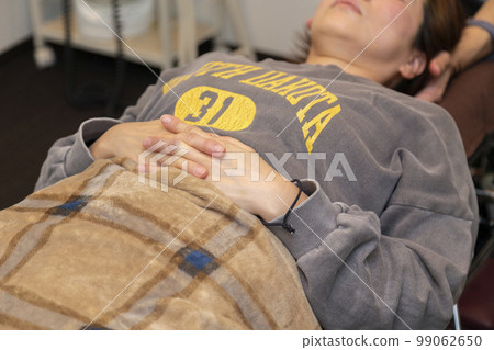 A woman receiving massage (bodywork, pelvic correction) A woman receiving massage (bodywork, pelvic correction) 99062650