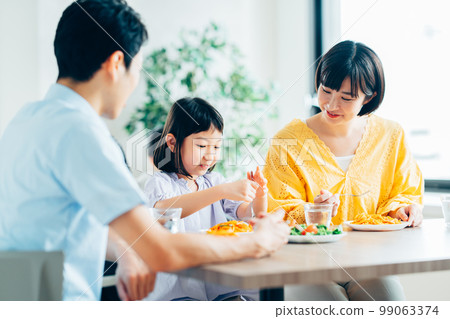 Parents and children having lunch at a restaurant 99063374