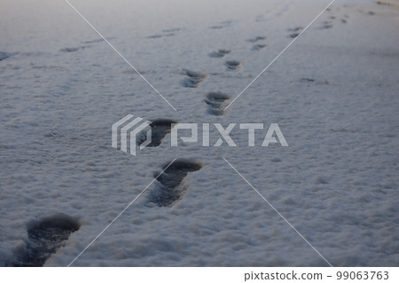 Footprints remaining in the snow Footprints remaining in the snow 99063763