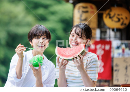 Young woman eating shaved ice and watermelon at a tourist spot Young woman eating shaved ice and watermelon at a tourist spot 99064610