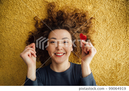 Smiling happy woman with hearts in her hands. Smiling happy woman with hearts in her hands. 99064919