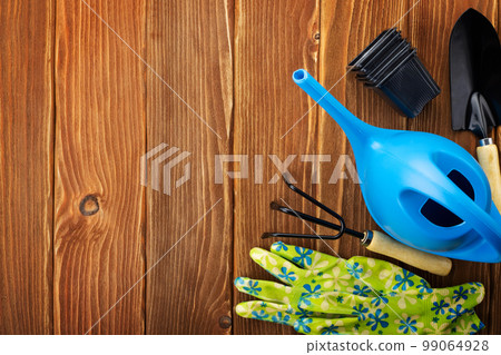 Garden tools on wooden background with space for text top view Garden tools on wooden background with space for text top view 99064928
