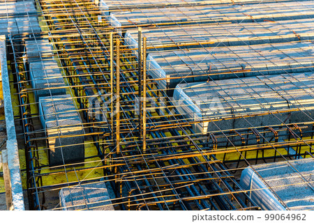 Concrete slab with reinforncing bars in construction site 99064962