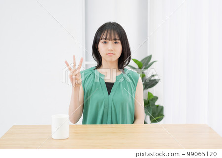 Woman showing the number 3 by hand Woman showing the number 3 by hand 99065120