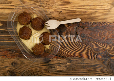 Falafel Balls in a Plastic Container, Fried Chickpea Balls, Traditional Arabic Street Food, Falafel on White Background 99065401