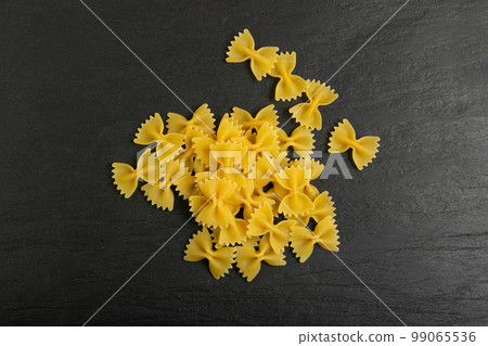 Raw Farfalle Pasta Isolated, Yellow Dry Noodles, Wheat Bow Macaroni, Uncooked Farfalle Top View 99065536
