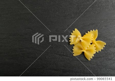 Raw Farfalle Pasta Isolated, Yellow Dry Noodles, Wheat Bow Macaroni, Uncooked Farfalle Top View 99065541