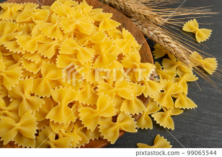 Raw Farfalle Pasta Texture Background, Yellow Dry Butterfly Noodles Pattern, Wheat Bow Macaroni Mockup 99065544