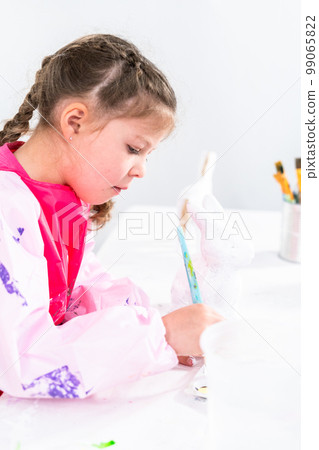 Little girl working on her art project for distance learning at home during COVID-19 pendemic. Little girl working on her art project for distance learning at home during COVID-19 pendemic. 99065822