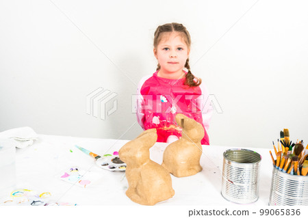 Little girl working on her art project for distance learning at home during COVID-19 pendemic. 99065836
