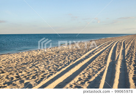 Sea coast. Wheel ruts on the sand. Sea coast. Wheel ruts on the sand. 99065978
