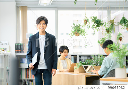 Young engineer in plain clothes working in the office 99065982